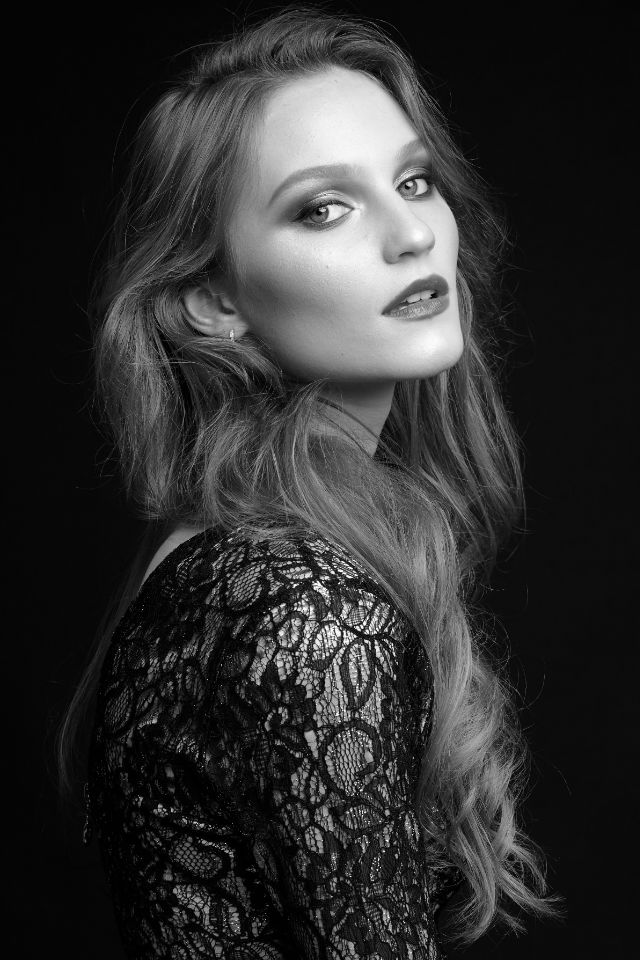 Nastya high-contrast studio portrait. Bold stare.